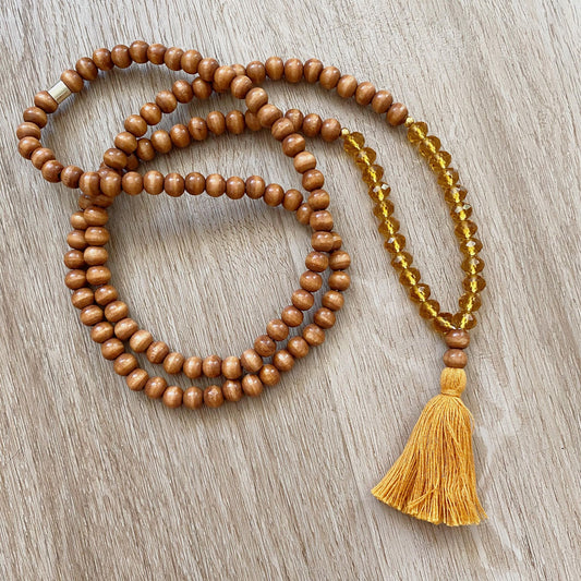 boho wooden beaded necklace with a tassel pendant and amber glass beads