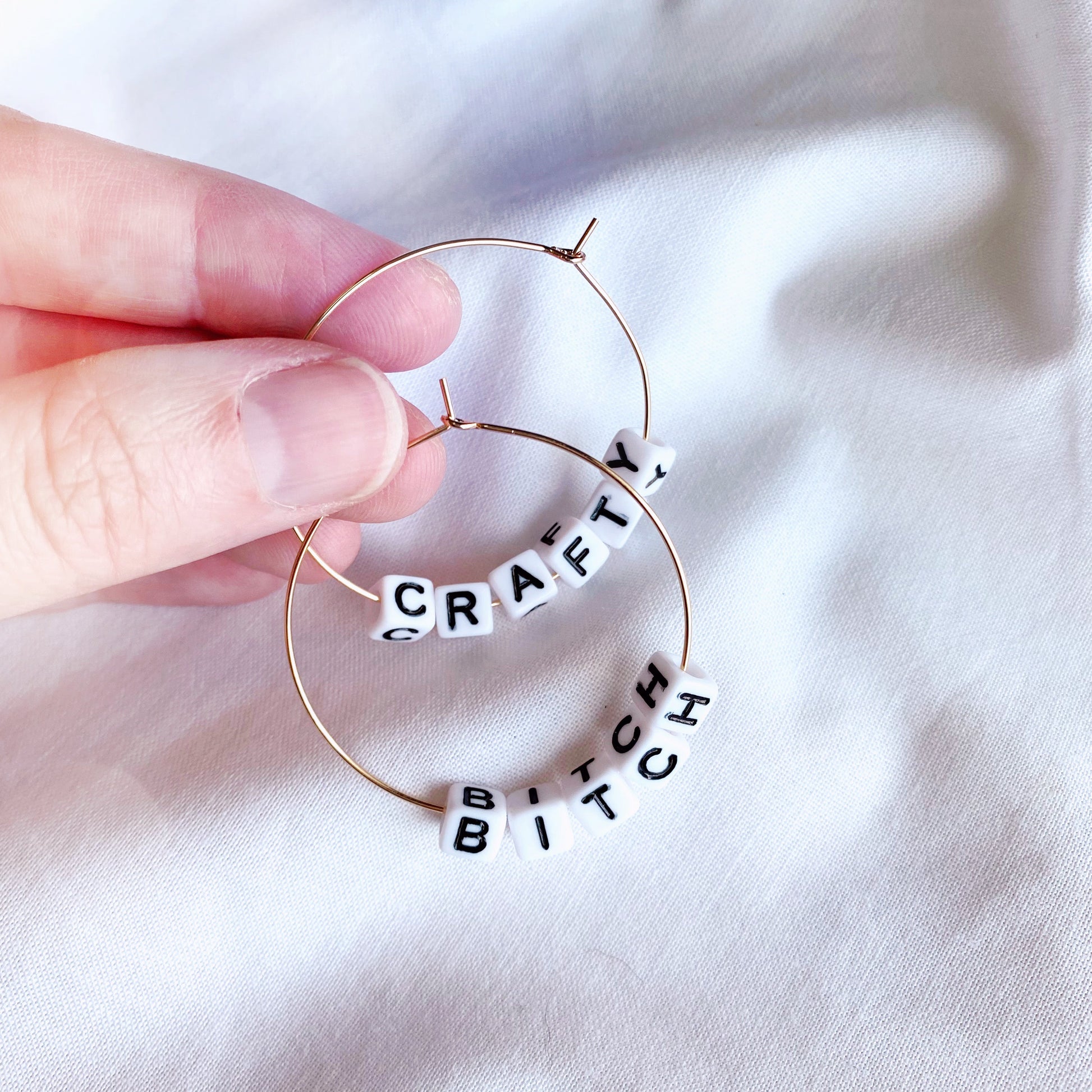 gold or silver hoop earrings, personalised with your name, or funny words