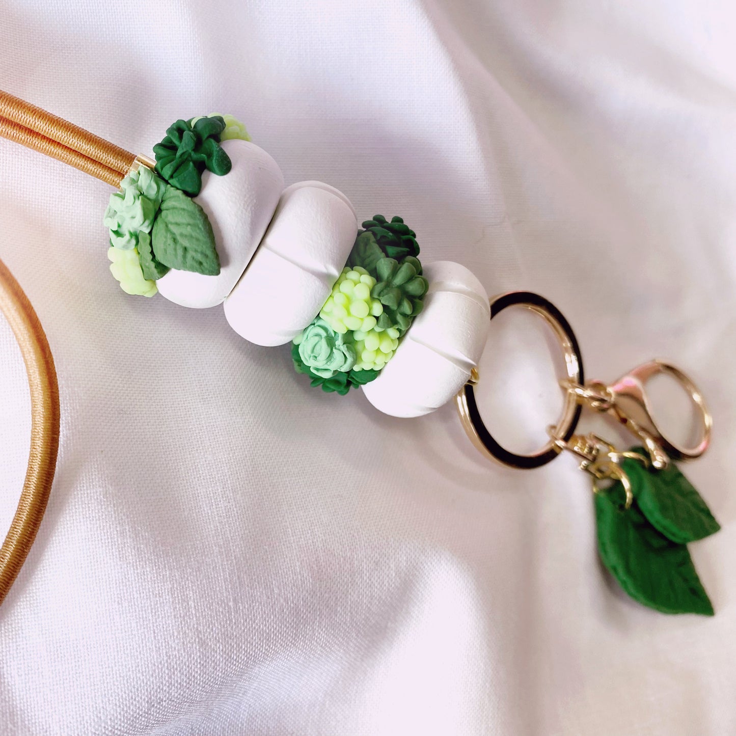 the plant lover lanyard has beautiful mini succulents and leaves, handmade with polymer clay