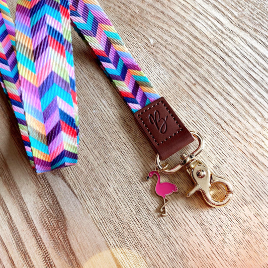 flamingo enamel charm attached to a fabric lanyard