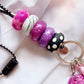 up close to the polymer clay beads, showing pink and purple glitter, black and white polkadots and marble