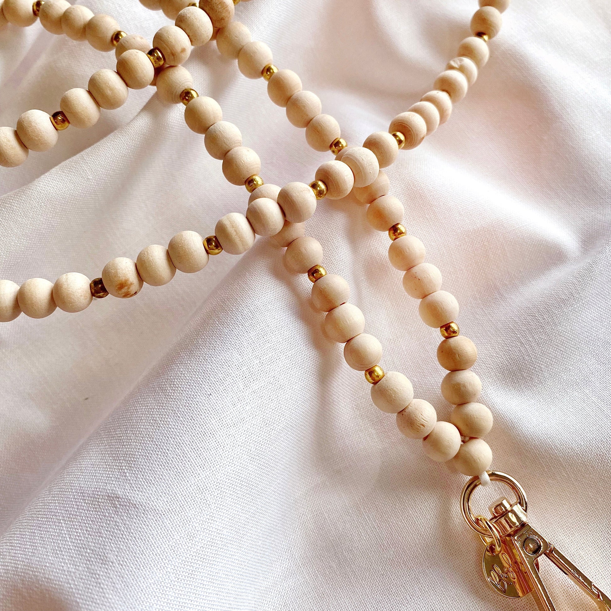 wooden beaded lanyard in a light wood colour with gold beads