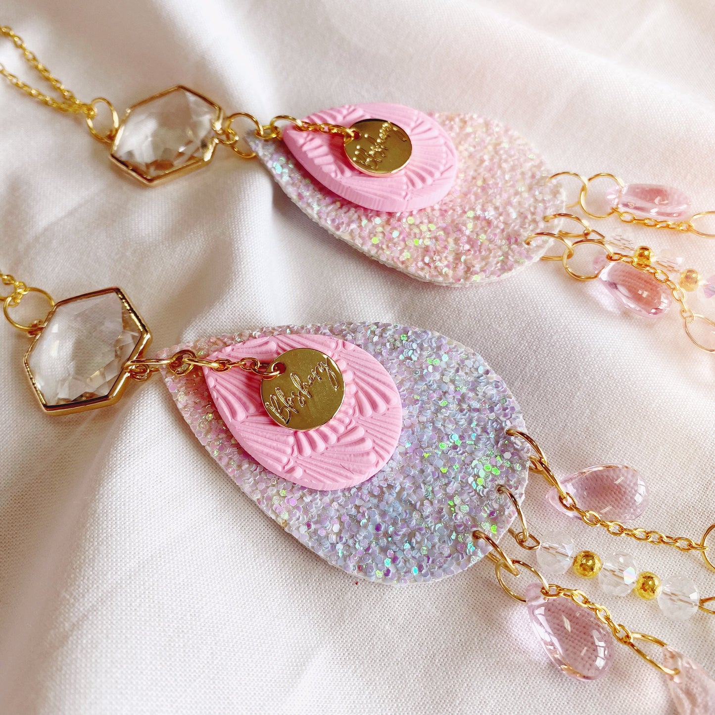 pink glitter and polymer clay pieces, with glass crystal beads to hang from the window