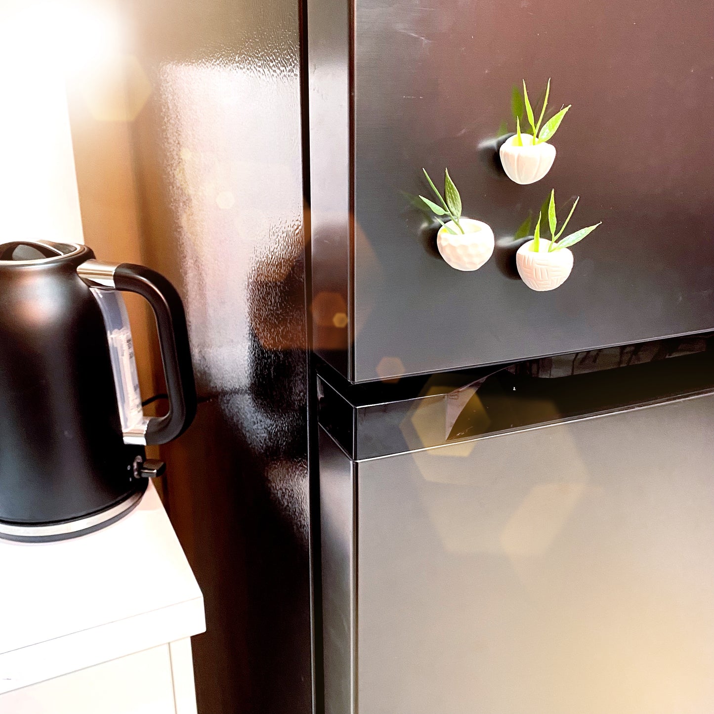 polymer clay handmade mini planters on display on the kitchen fridge