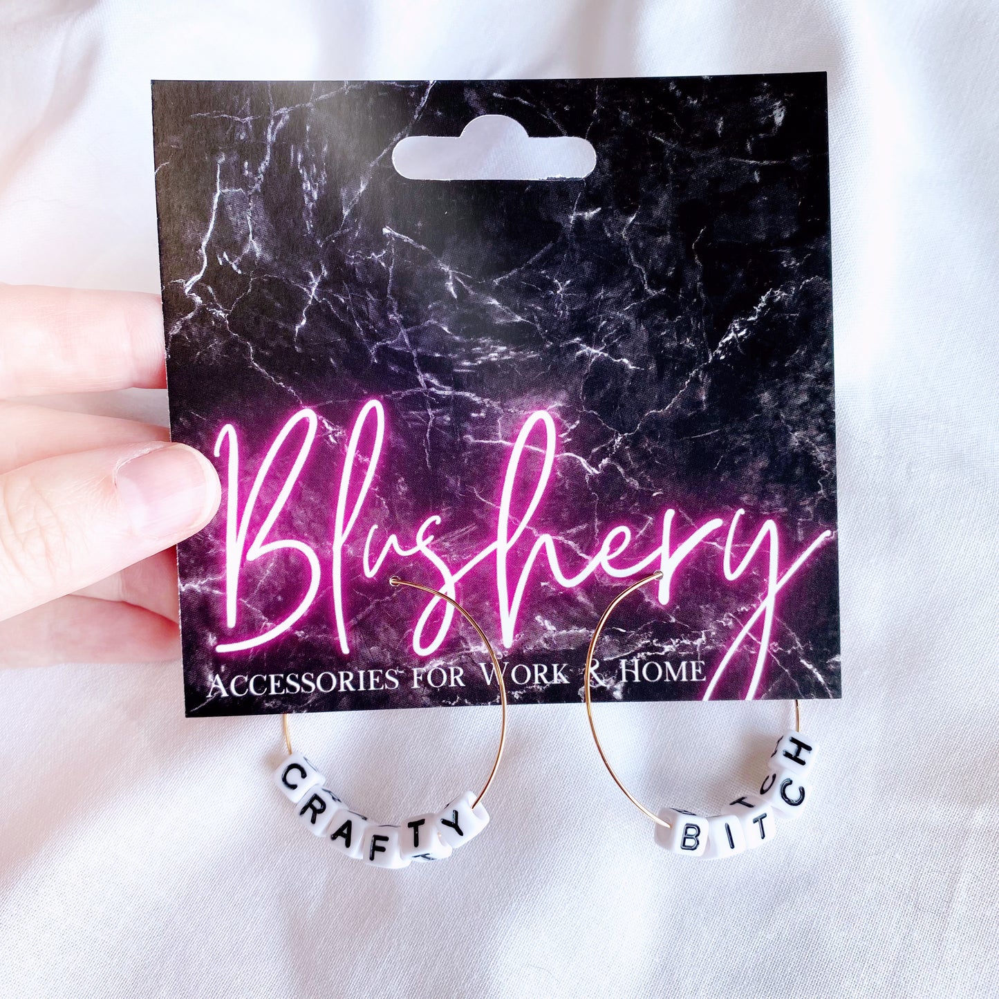 funny beaded hoop earrings, with tiny alphabet beads saying crafty bitch