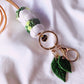 the succulent lanyard features gold plated clasps and leaf charms