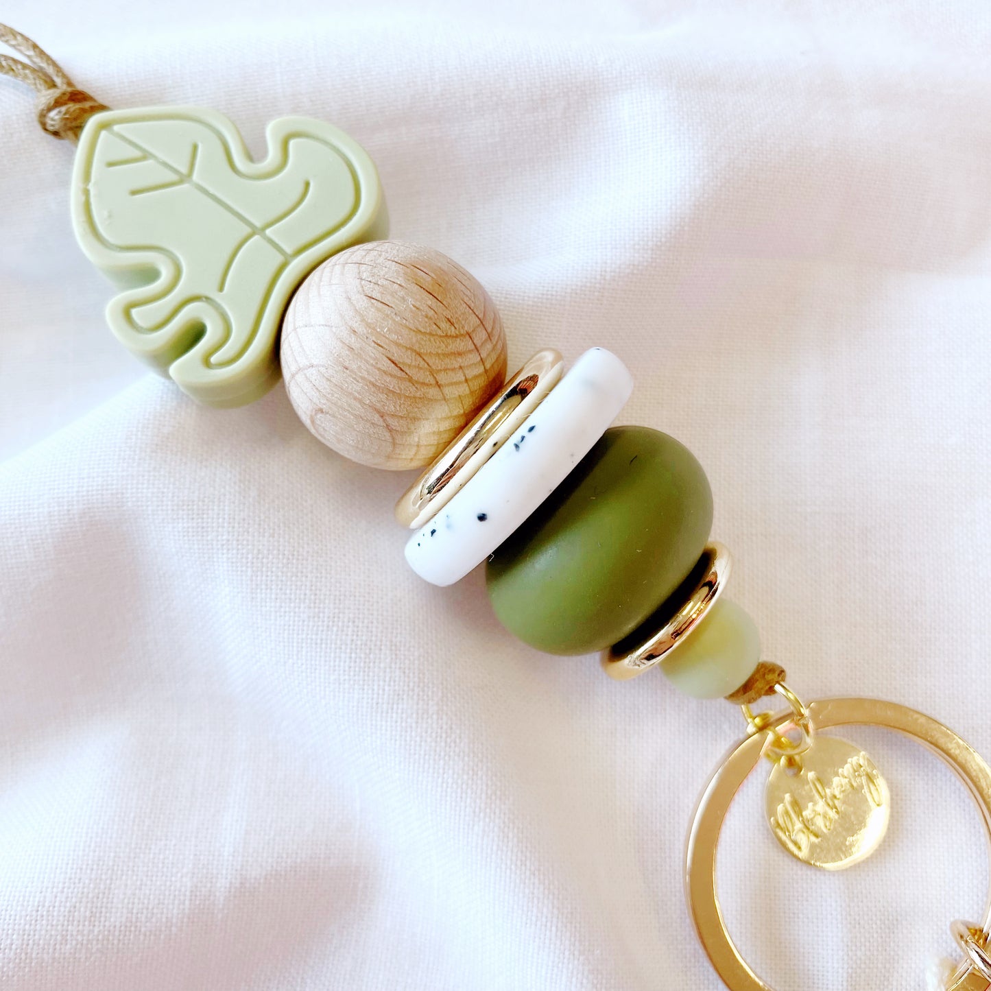 green leaf silicone beads, wood, white and gold make up this teacher lanyard
