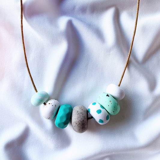 beaded polymer clay necklace with teal and mint beads