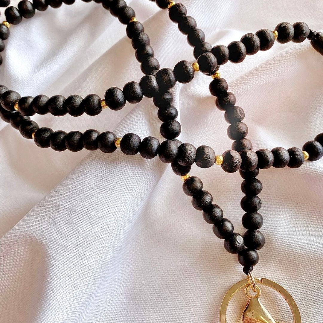 black wooden beaded lanyard with gold beads