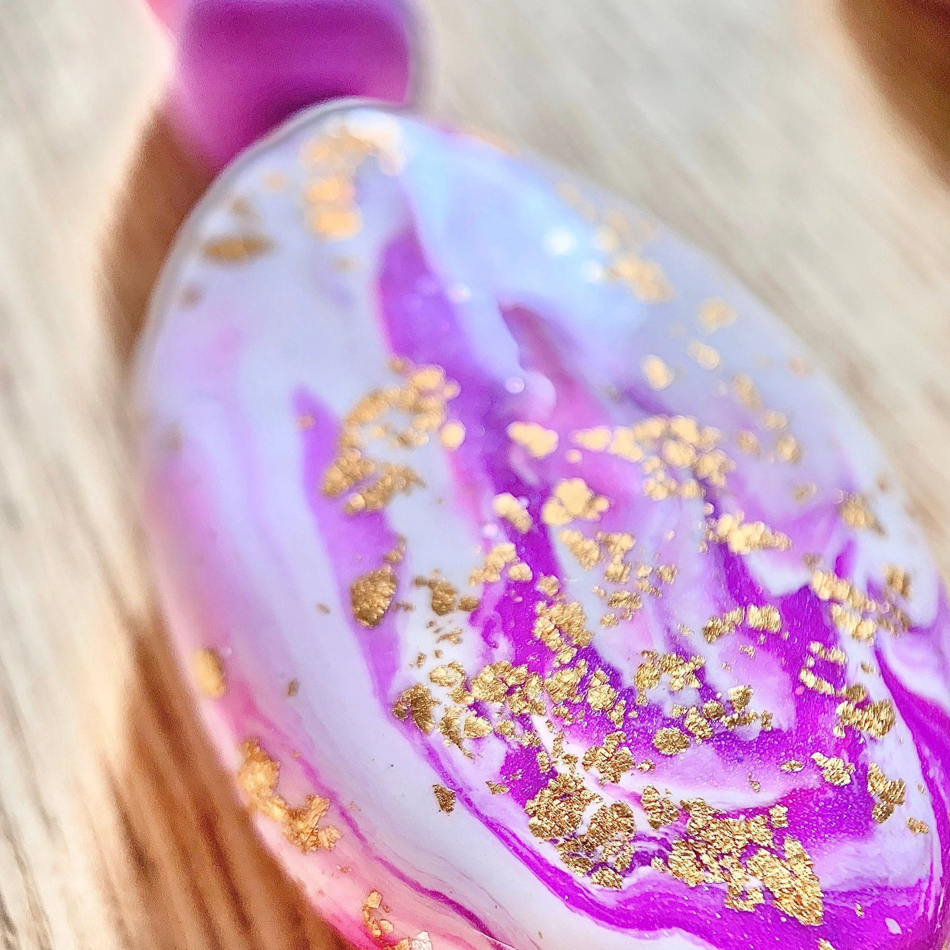 up close to the intricate details including purple and white clay and gold leaf foil to look like a precious gemstone