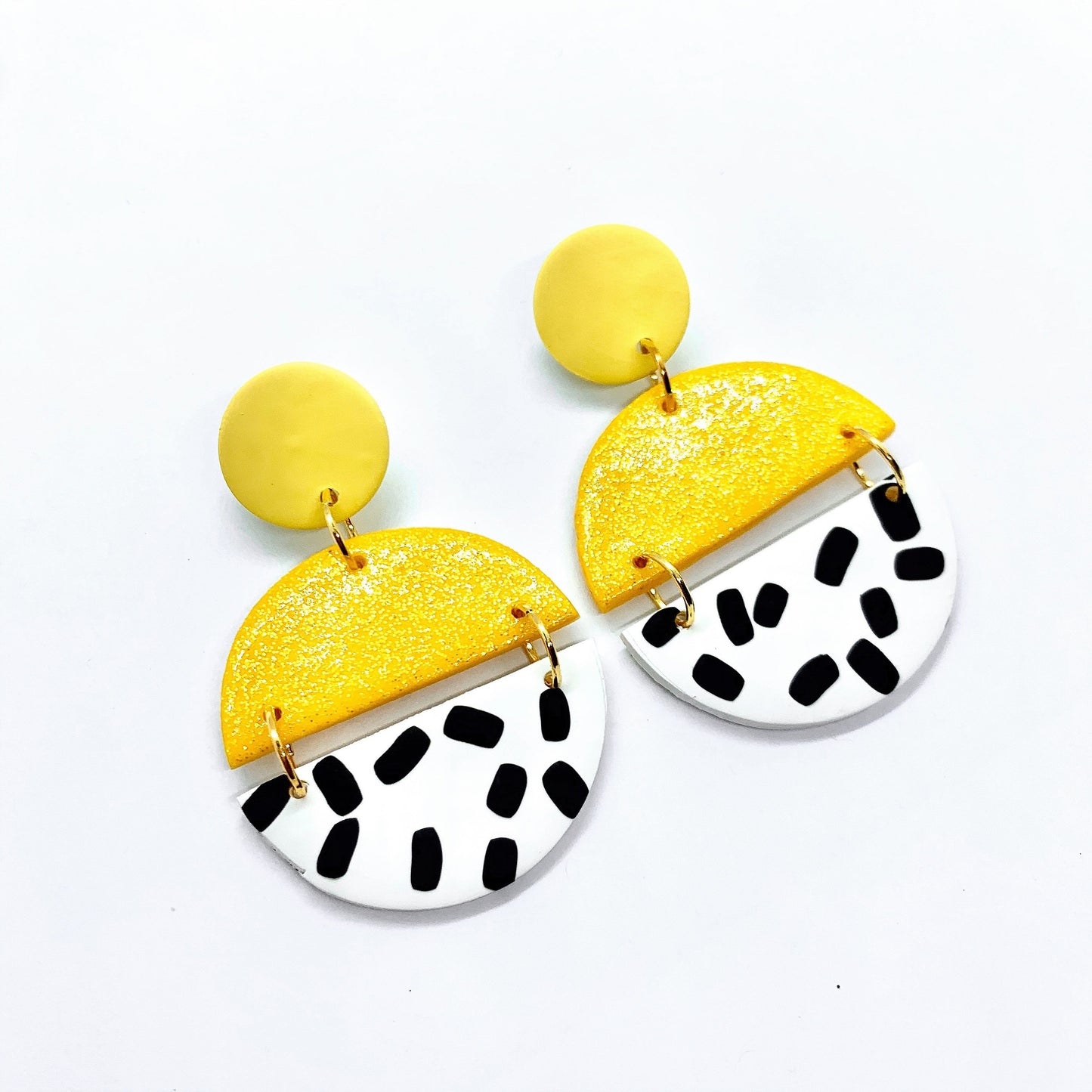 handmade polymer clay earrings in yellow glitter and black and white polka-dots