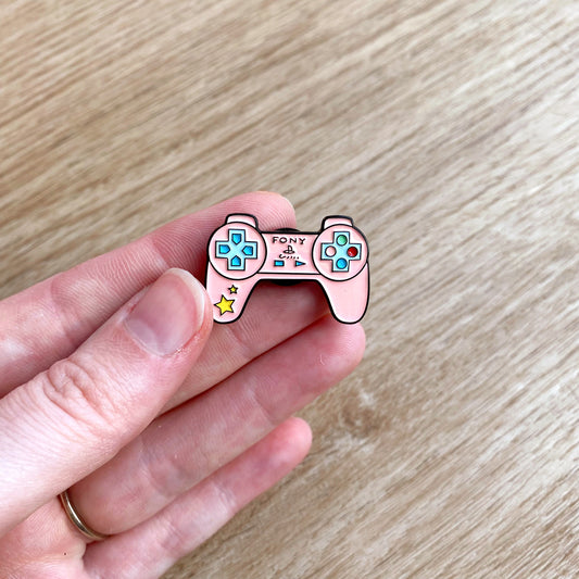 Enamel brooch lapel pin in pink playstation controller design