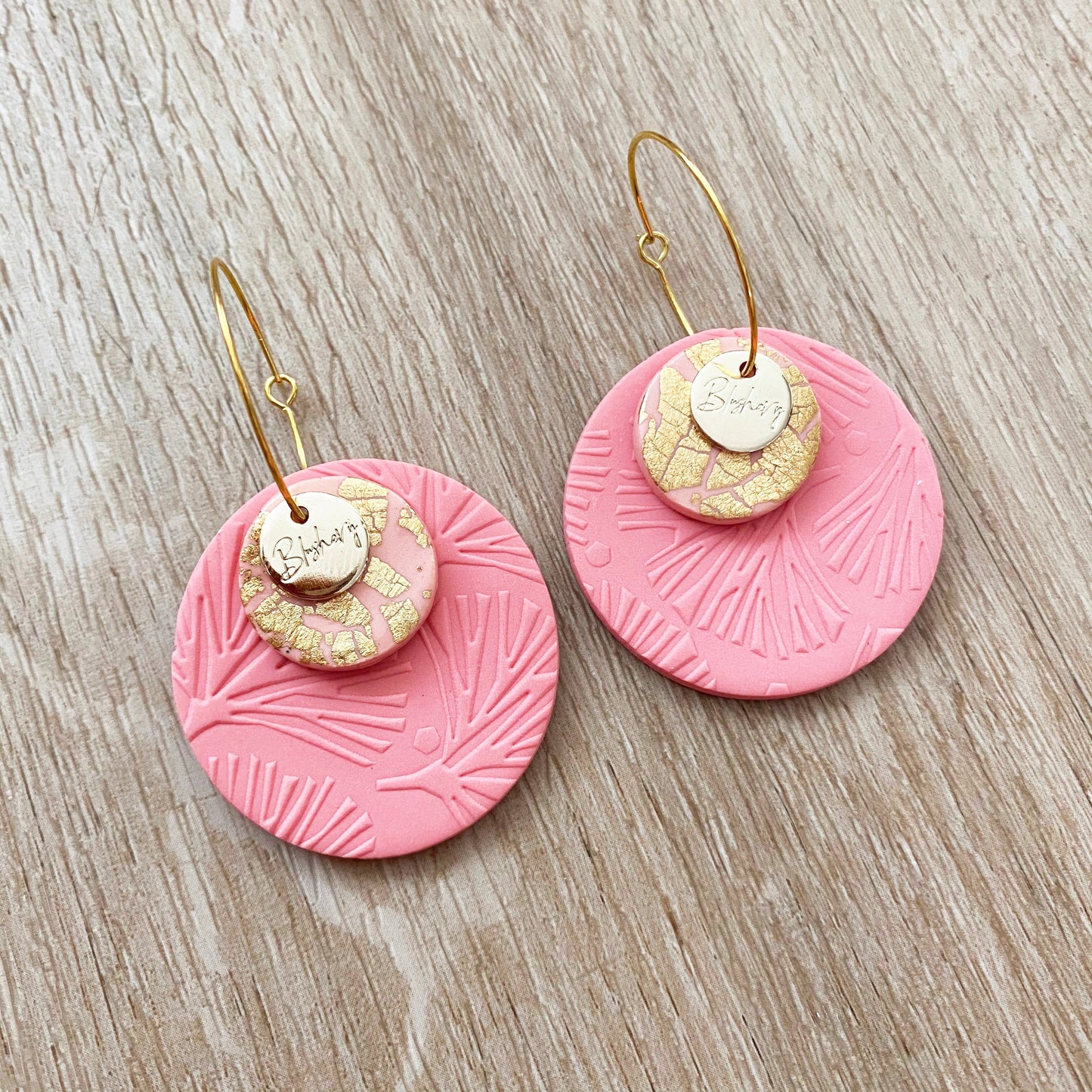 coral pink stacked disc hoop earrings, round circle shapes with foliage leaf print and gold accents