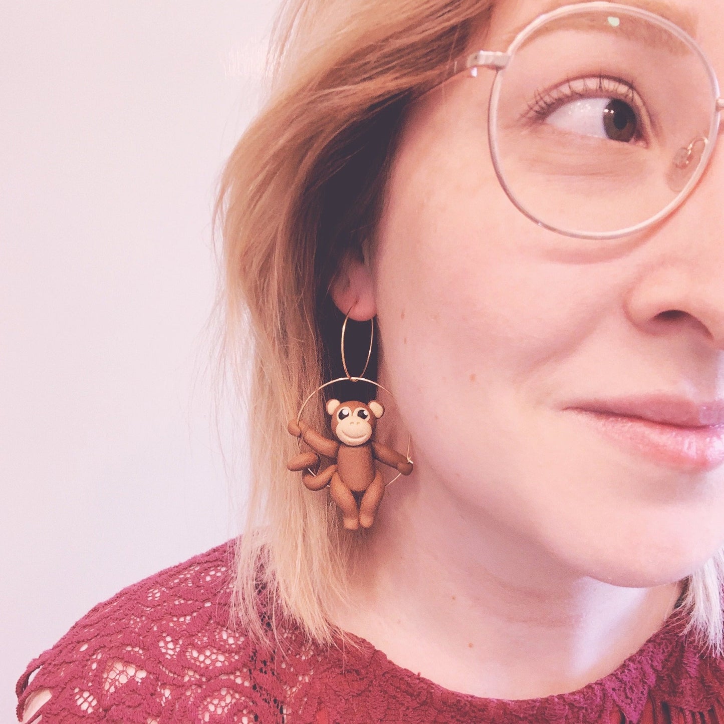 cheeky monkey earring selfie showing the polymer clay monkey hanging from hoop earring