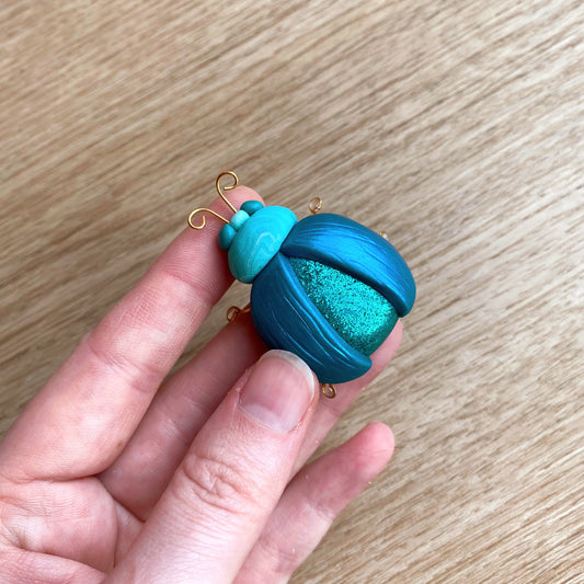 traditional beetle brooch pin in teal colour, made with polymer clay