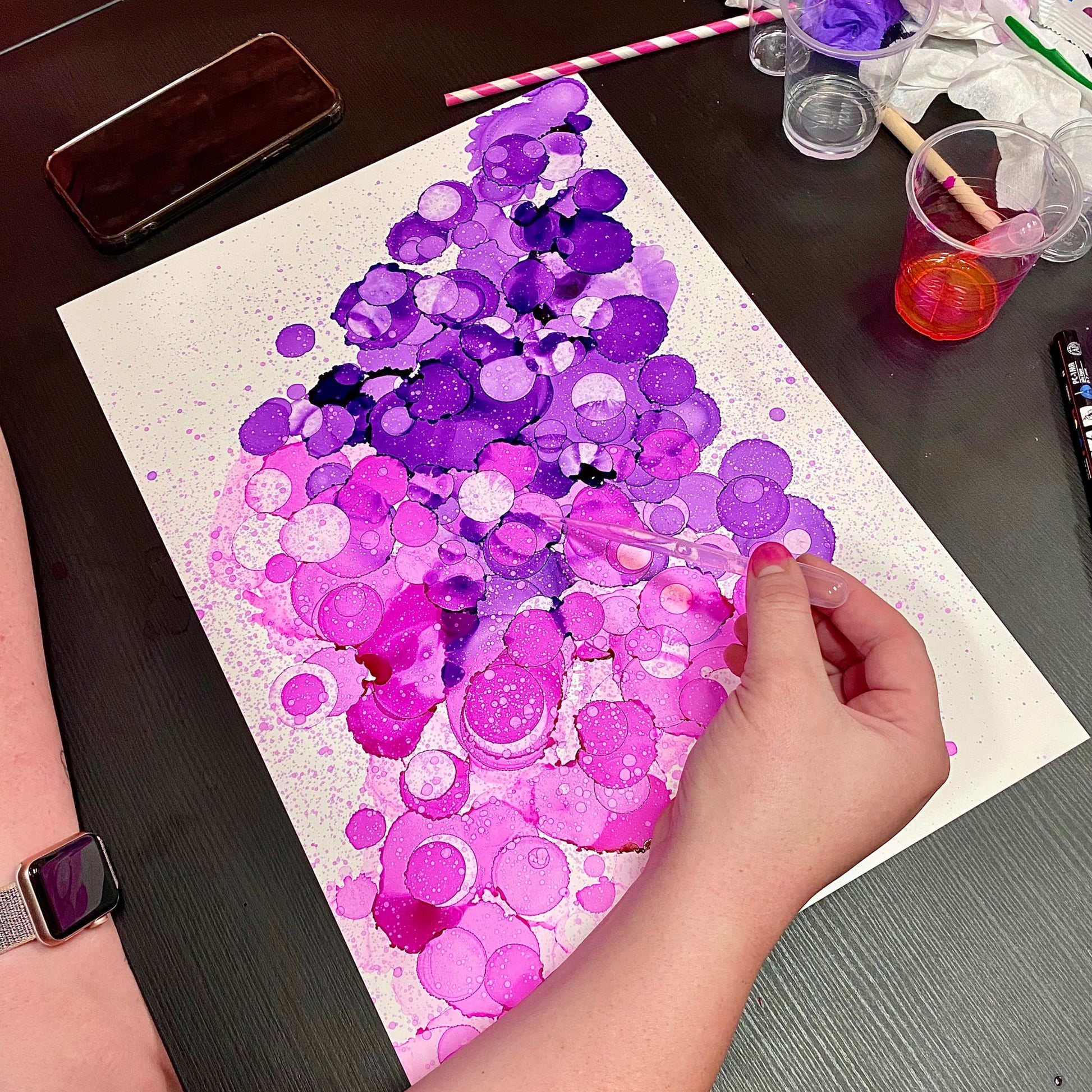pink and purple alcohol inks dotted on the paper