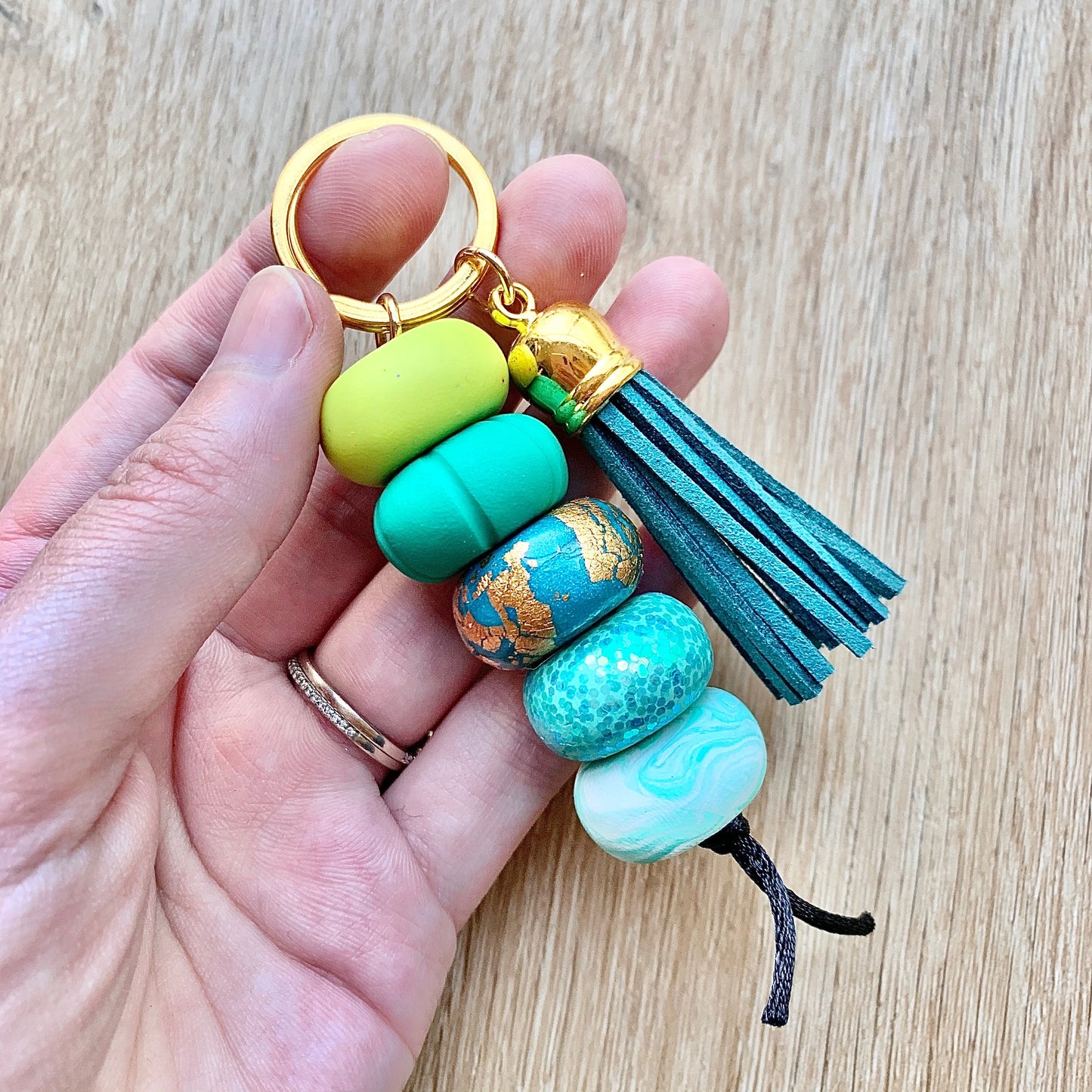 blue and green beaded polymer clay keychain with tassel
