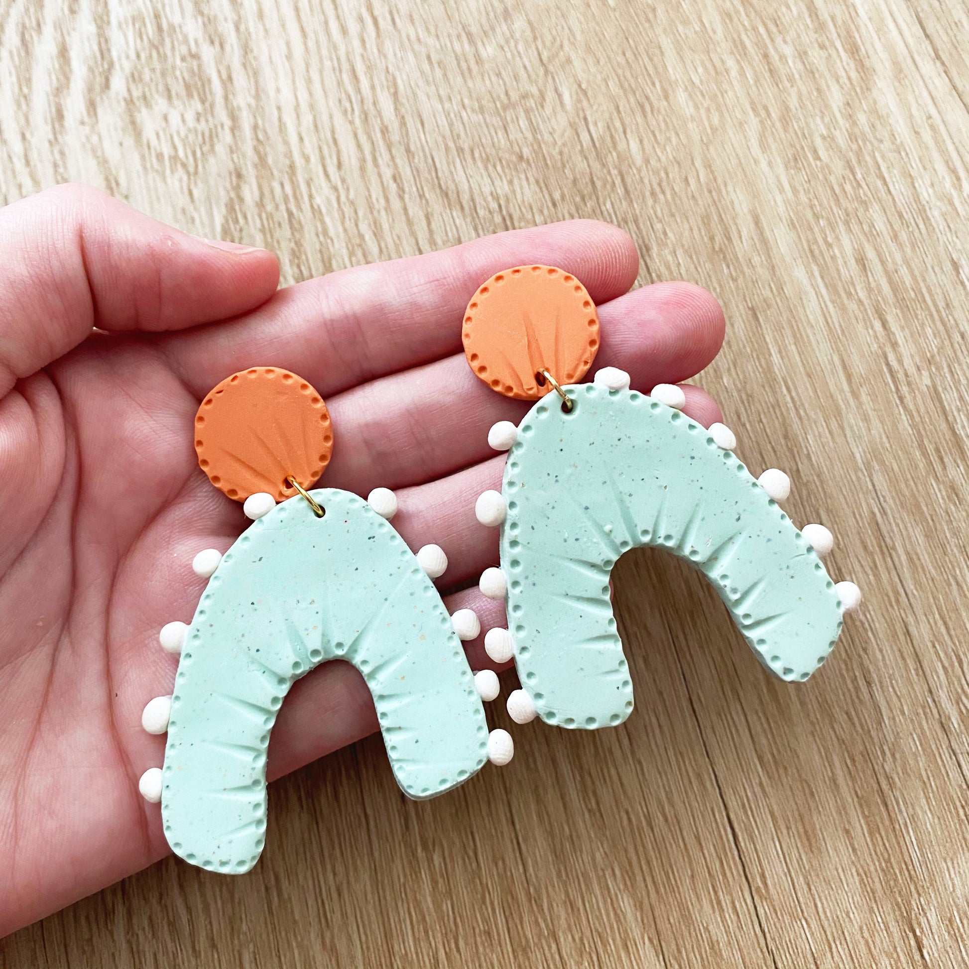 rainbow arch earrings in blue and orange, perfect for teachers